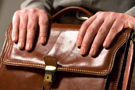 Businessman leaning on briefcase