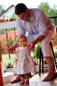 Father and baby girl in garden