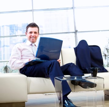 Smiling businessman with laptop