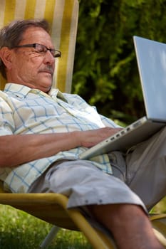 Senior man using laptop outdoor
