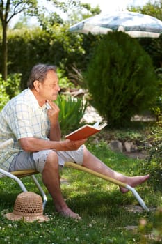 Elderly man reading book