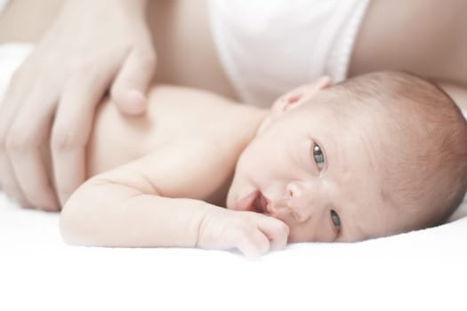 Mother fondles newborn baby