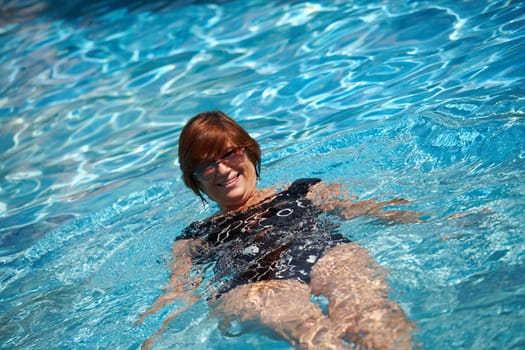 Active senior woman swimming