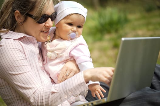 Mother uses a laptop