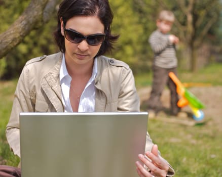 Mother uses laptop