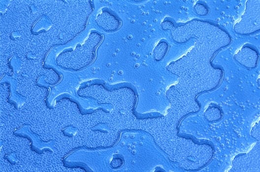 Water drops over blue plastic material
