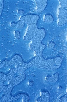 Water drops over blue plastic material