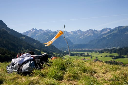 Windsock and backpacks in the mountains. Oberallgäu near Fischen