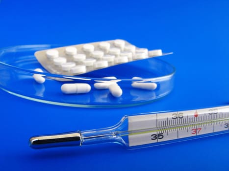 medical pills and thermometer - detail