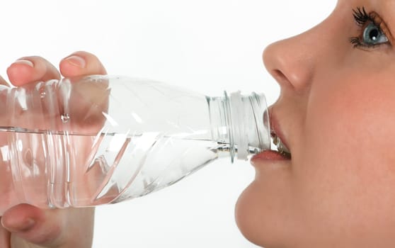 Beautiful girl drinking mineral water