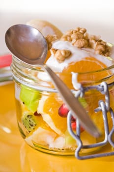 Fruit salad in a mason jar with yoghurt
