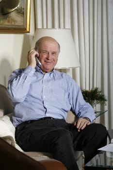 Cheerful senior on the phone