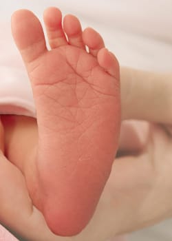 Tiny foot of a newborn baby