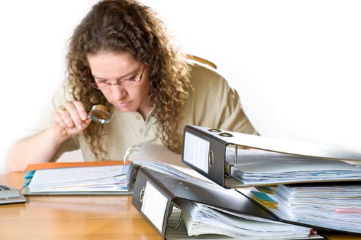 Woman in office in front of many folders