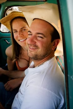 Cowboy and woman in pickup truck