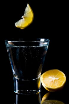 Glass of water against black background