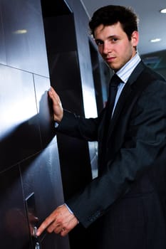 Businessman calling elevator