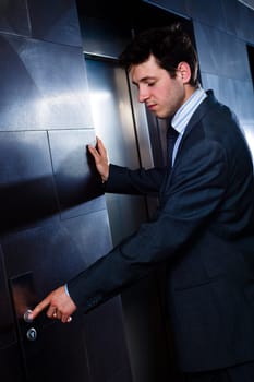 Businessman calling elevator