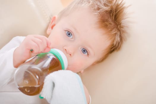 Baby boy drinking from bottle