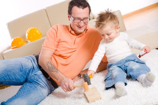 Father and baby boy playing
