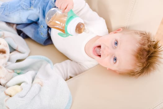Baby boy drinking from bottle