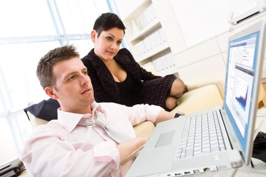 Businesspeople working on computer