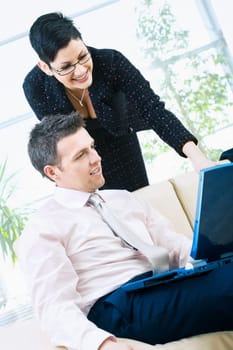 Happy businesspeople with computer