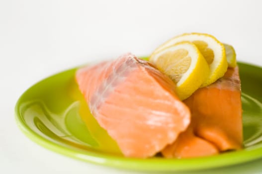 Salmon fillet on green plate