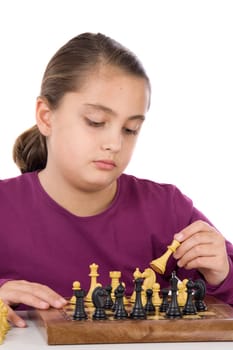 Attractive little girl playing chess