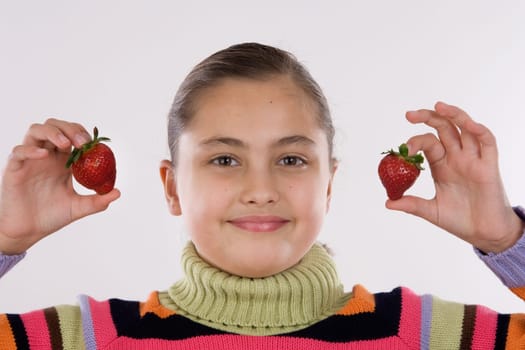 Cute girl holding two strawberries