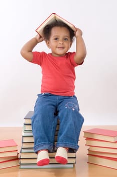 Baby sitting on a pile of books