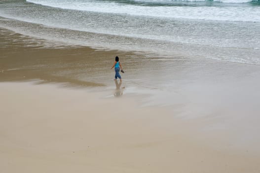 Beautiful girl walking on the beach