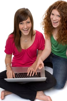 Two teenagers using laptop