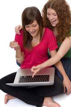Two teenagers using laptop