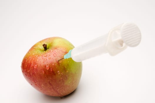 Apple with syringe