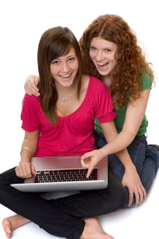 Two teenagers using laptop