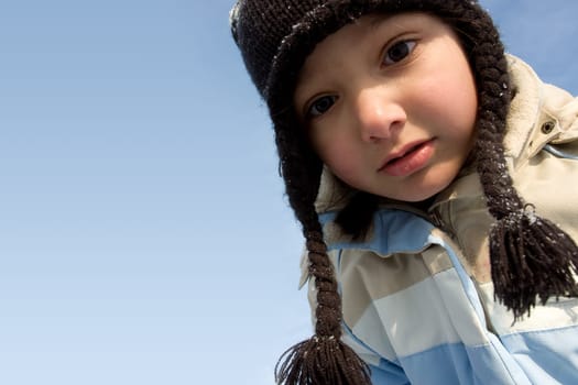 Portrait of Winter girl over blue sky