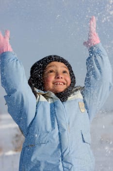 Cute little girl surrounded by snowflake