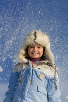 Cute little girl surrounded by snowflake