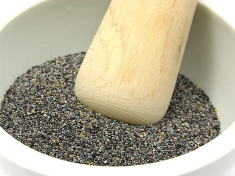 Poppy seeds in porcelain bowl with mortar