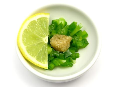Green bell pepper pieces with sugar and lemon in porcelain bowls