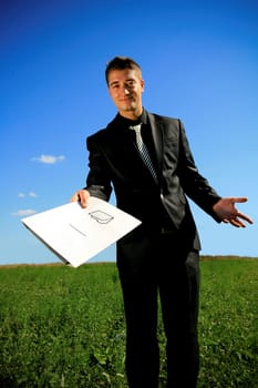Young businessman handing a folder