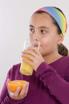 Girl drinking a juice of orange