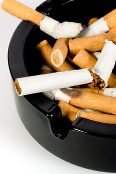 Close-up of cigarettes butts in ashtray