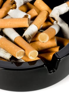 Close-up of cigarettes butts in ashtray
