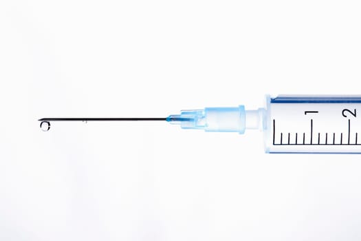 Drop of a liquid on a needle of syringe