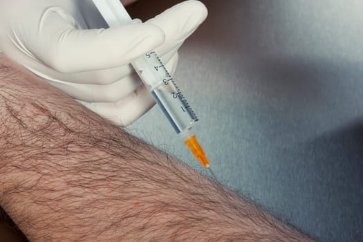 Syringe in a hand ready for injection