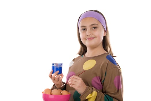 Adorable girl adorning Easter eggs