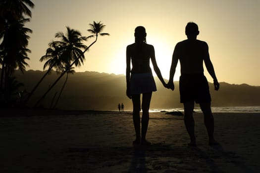 Couple in love on the beach at sunset
