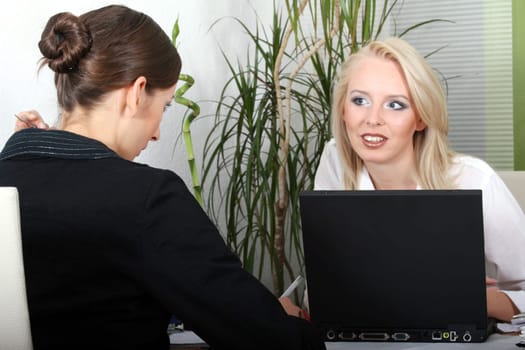 Two women discussing at workplace